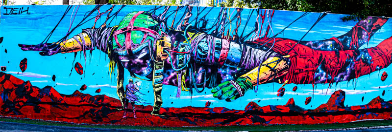 Human figure mural with intricate detail and saturated color